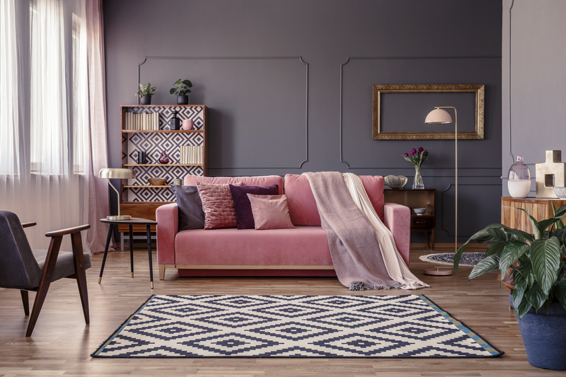 bright pink sofa, rug on the floor and curtains